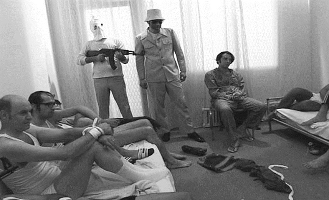 Israeli Olympic Team members being held captive by Black September before their eventual deaths during the Munich Massacre in 1972. Source: oldpicz.com