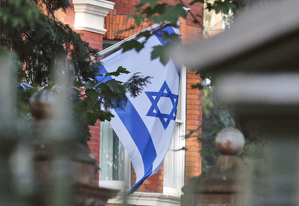 An Israel flag hangs in front of the Israeli Embassy as a reaction to the death of former Israeli Prime Minister Shimon Peres, in London, Wednesday, Sept. 28, 2016. Peres, a former Israeli president and prime minister, whose life story mirrored that of the Jewish state and who was celebrated around the world as a Nobel Prize-winning visionary who pushed his country toward peace, died early Wednesday. He was 93. (AP Photo/Frank Augstein)